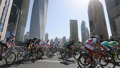 Cyclists take part in the first stage of the Dubai Tour, from Dubai International Marina to Union House Flag, on February 4, 2015. Teams from more than seven countries are taking place in the 2015 cycling tour which will cover 660 kilometres in four days. AFP PHOTO / KARIM SAHIB