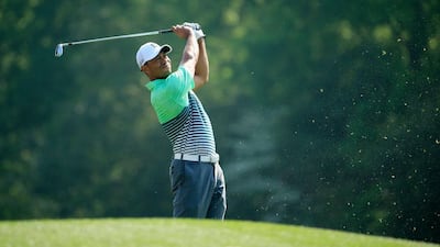 Tiger Woods watches a tee shot during a practice round at the Augusta National Golf Club. Jamie Squire / Getty Images