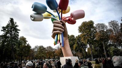 Spectators attend the unveiling of the 'Bouquet of Tulips' sculpture by US artist Jeff Koons near The Petit Palais Museum in Paris, France. AFP
