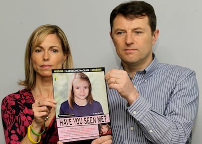 Kate and Gerry McCann pose with a missing poster depicting an age-progression, computer-generated image of their missing daughter in 2012. AP