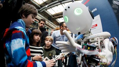 File photo of children interacting with the humanoid robot Roboy at the exhibition Robots on Tour in Zurich. Reuters