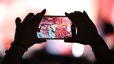 A fan takes an up-close photo of Chanyeol while he performs