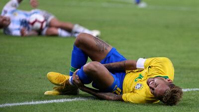 Neymar lies on the pitch during the friendly match at the King Abdullah Sport City Stadium. AFP