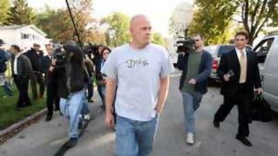 Joe Wurzelbacher walks to a neighbour's home followed by reporters.
