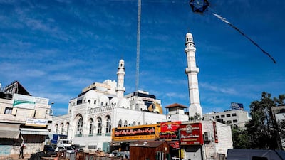 A kite is being flown near the Jamal Abdel Nasser Great Mosque in the centre of the occupied West Bank city of Ramallah. AFP