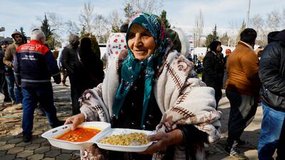 A woman carries a box of food in Kahramanmaras, Turkey. Reuters