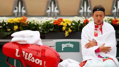 Victoria Azarenka wraps up warm during her French Open first round match against Danka Kovinic. Reuters