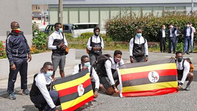 Members of Uganda’s Olympic team pose for a photo on their arrival in Izumisano, western Japan, on Sunday, June 20. A member of the squad has tested positive for Covid-19. AP