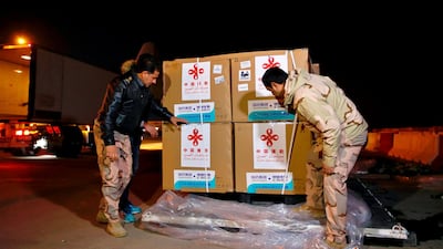 Air freight workers examine the consignment of the Sinopharm vaccine at Baghdad International Airport, Baghdad. Iraq has an arrangement with Sinopharm to supply two million doses. AP Photo