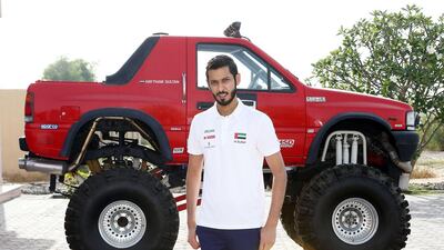 Emirati racing driver Haytham Sultan with one of the cars from his collection at his home in Umm Al Quwain. Pawan Singh / The National
