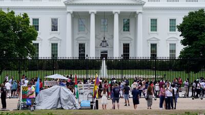 People gather on a section of Pennsylvania Avenue that was reopened to the public in front of the White House in Washington, DC.