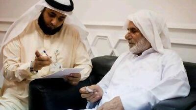 Applicants submit paperwork at the Sheikh Zayed Mosque in Ajman to go to Haj for free through the Zayed Bin Sultan Al Nahyan Charitable and Humanitarian Foundation. Razan Alzayani / The National