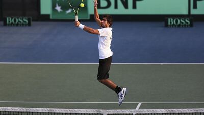 Hamad Janahi of the UAE leaps to return a volley from Hoang Thien Nguyen of Vietnam during their Davis Cup qualifying match at Dubai. Sarah Dea / The National