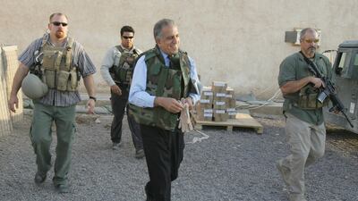 US Ambassador to Iraq Zalmay Khalilzad wearing a flack jacket and surrounded by bodyguards from the US security firm Blackwater in 2005. AFP