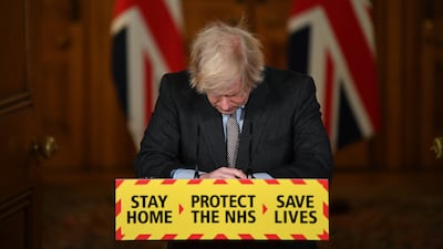 UK Prime Minister Boris Johnson looks down at the podium during a media briefing in Downing Street in January, 2021. Press Association