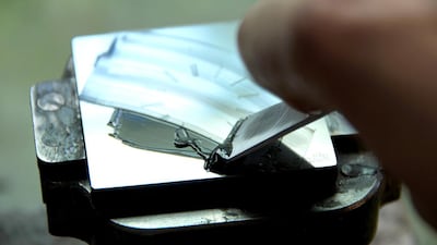 A watchmaker works on the dial of a timepiece. Courtesy Atelier Laurent Ferrier