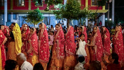 Brides arrive to get married during a mass wedding ceremony in Varanasi. AFP