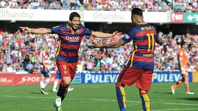 Luis Suarez (L) of Barcelona celebrates scoring his team’s third goal and his hat trick goal with his team mate Meymar (R) during the La Liga match between Granada and Barcelona at Estadio Nuevo Los Carmenes on May 14, 2016 in Granada, Spain. (Photo by Denis Doyle/Getty Images)