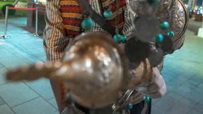 A man offering Turkish tea to guests.