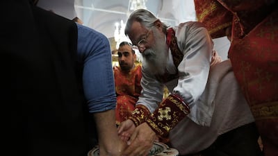 A Christian Orthodox bishop washes the feet of a man during a mass of holy week at the Panayia Faneromeni Orthodox Church capital Nicosia, Cyprus. AFP