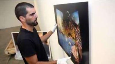 Haig Aivazian, artist liaison and exhibitions director for The Third Line gallery, prepares the latest exhibition, Roads Were Open/Roads Were Closed.