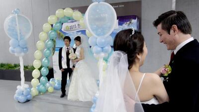 Couple waits for their wedding ceremony of the Family Federation for World Peace and Unification, commonly known as the Unification Church, at Cheongshim Peace World Center on March 3, 2015 in Gapyeong-gun, South Korea. Approximately 3,800 couples from around the world exchanged wedding vows in the wedding the Unification Church claims as one of its largest ever. Chung Sung-Jun / Getty Images