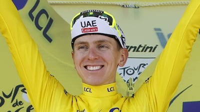 Slovenian rider Tadej Pogacar of UAE Team Emirates celebrates in the overall leader's yellow jersey. EPA