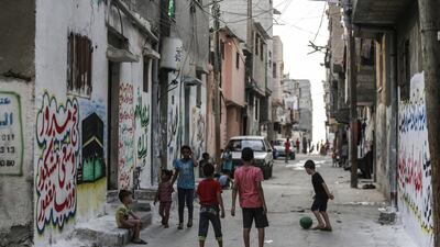 Palestinian refugees pass the time in the Shateaa camp in the north west of Gaza City. EPA/HAITHAM IMAD