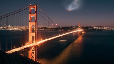 The SpaceX Falcon 9 rocket launch is seen in the distance over the Golden Gate Bridge near Sausalito, California. Justin Borja via AP