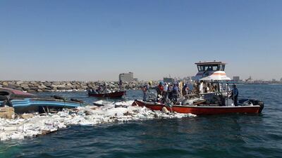 Dubai Municipality recovered flotsam after a commercial ship loaded with goods sank in Dubai Creek. Dubai Municipality