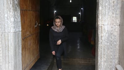 Ms Haji passes through the doorway of the Lalish temple to pay tribute to villagers who were victims of ISIS. AFP