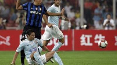 Inter Milan's new defensive signing from Bayern Munich Lucio, left, challenges Lazio's Mauro Zarate, bottom, during the Rome side's 2-1 Italian Super Cup victory at the Bird's Nest stadium in Beijing yesterday.