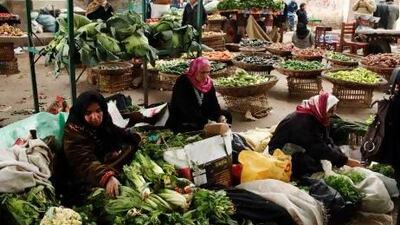 Women sell vegetables at a market in Zagazig in the Nile delta. The Egyptian economy was stagnant last year. Asmaa Waguih / Reuters