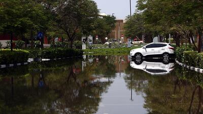 Hundreds of people were stranded for hours at Ibn Battuta Mall after a burst main pipe left their cars submerged in water near Discovery Gardens. Satish Kumar / The National