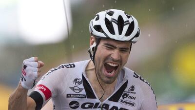Tom Dumoulin celebrates as he crosses the finish line to win the ninth stage of the Tour de France on Sunday. Peter Dejong / AP Photo