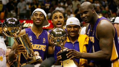 Bryant, holding the championship trophy, celebrates with teammates Rick Fox, Lindsey Hunter and Shaquille O'Neal in 2002. AP