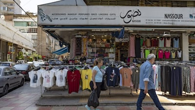 Shoppers pass a clothing store in the Burj Hammoud district of Beirut, Lebanon. Bloomberg