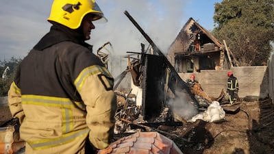 Firefighters work at the site of a Russian missile strike in the village of Sknyliv on the outskirts of Lviv, Ukraine. Reuters