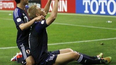 Keisuke Honda, right, celebrates scoring his second goal against Jordan with Shinji Kagawa. Honda finished with three tallies in Japan's 6-0 win.
