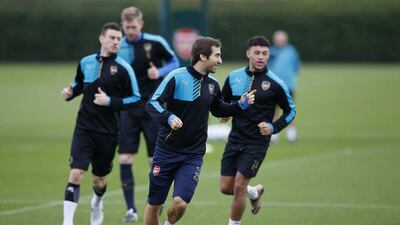 Mathieu Flamini leads his Arsenal teammates in a run at Tuesday’s training session. Paul Childs / Action Images / Reuters