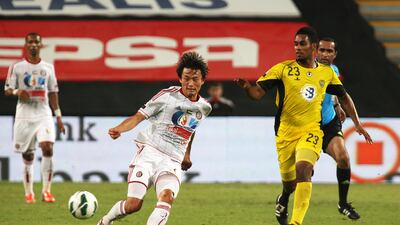 Wasl's Mohamed Jamal chases down Jazira's Hyung-min Shin at Mohammad Bin Zayed stadium. Pawan Singh / The National