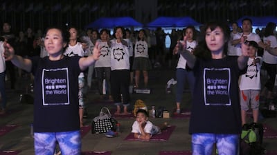 People perform yoga to mark the International Day of Yoga in Seoul, South Korea. Ahn Young-joon / AP photo