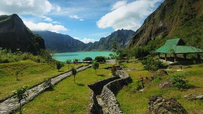 Manicured pathways leading to the turquoise waters of Mount Pinatubo Crater, one of the highlights for visitors to Clark in the Philippines. Getty Images