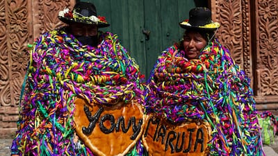 Aymara indigenous people celebrate the "Roscasiri", the change of command of local authorities, in Pomata District, one of seven districts of the Chucuito Province in the Puno Region, southern Peru. - This ancient Aymara event, in which people adorn themselves with breads and fruits that represent abundance for the new year, celebrates the change of command of local authorities.