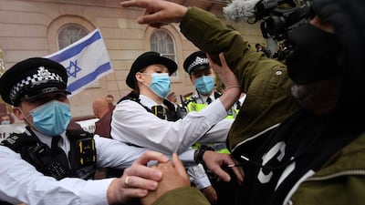 Police officers intervene between pro-Israel and pro-Palestinian activists participating in rival demonstrations, outside Downing Street in central London. AFP