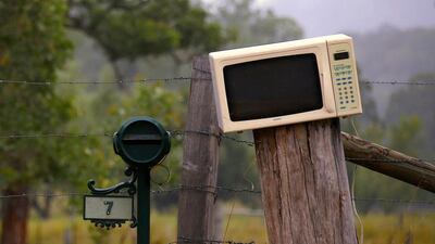 An old microwave used as a mailbox can be seen next to a more traditional one in Wollombi.