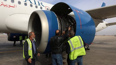 SyrianAir maintenance employees check a grounded Airbus A320 of SyrianAir at Damascus Airport in Syria, after rebels took control of the complex. EPA