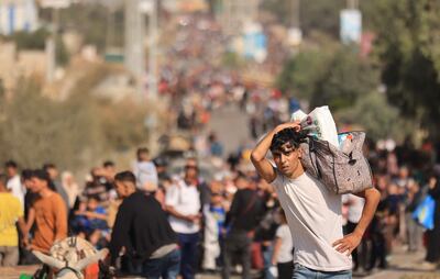 A Palestinian man carries his belongings as families flee Gaza city and other parts of the northern strip. AFP