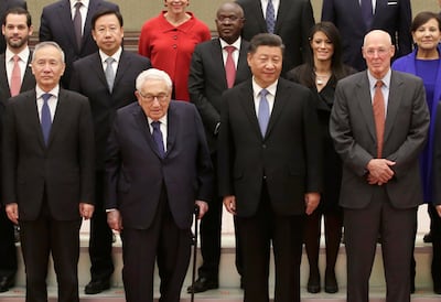 Chinese President Xi Jinping, center left, and Vice Premier Liu He, left, attend a group photo session with former U.S. Secretary of State Henry Kissinger, center left, former U.S. Treasury Secretary Henry Paulson, right. Jason Lee / AP