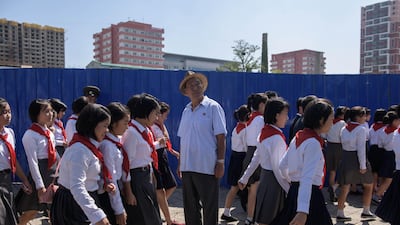 Participants and spectators make their way away from on Kim Il Sung square following a military parade and mass rally in Pyongyang. AFP